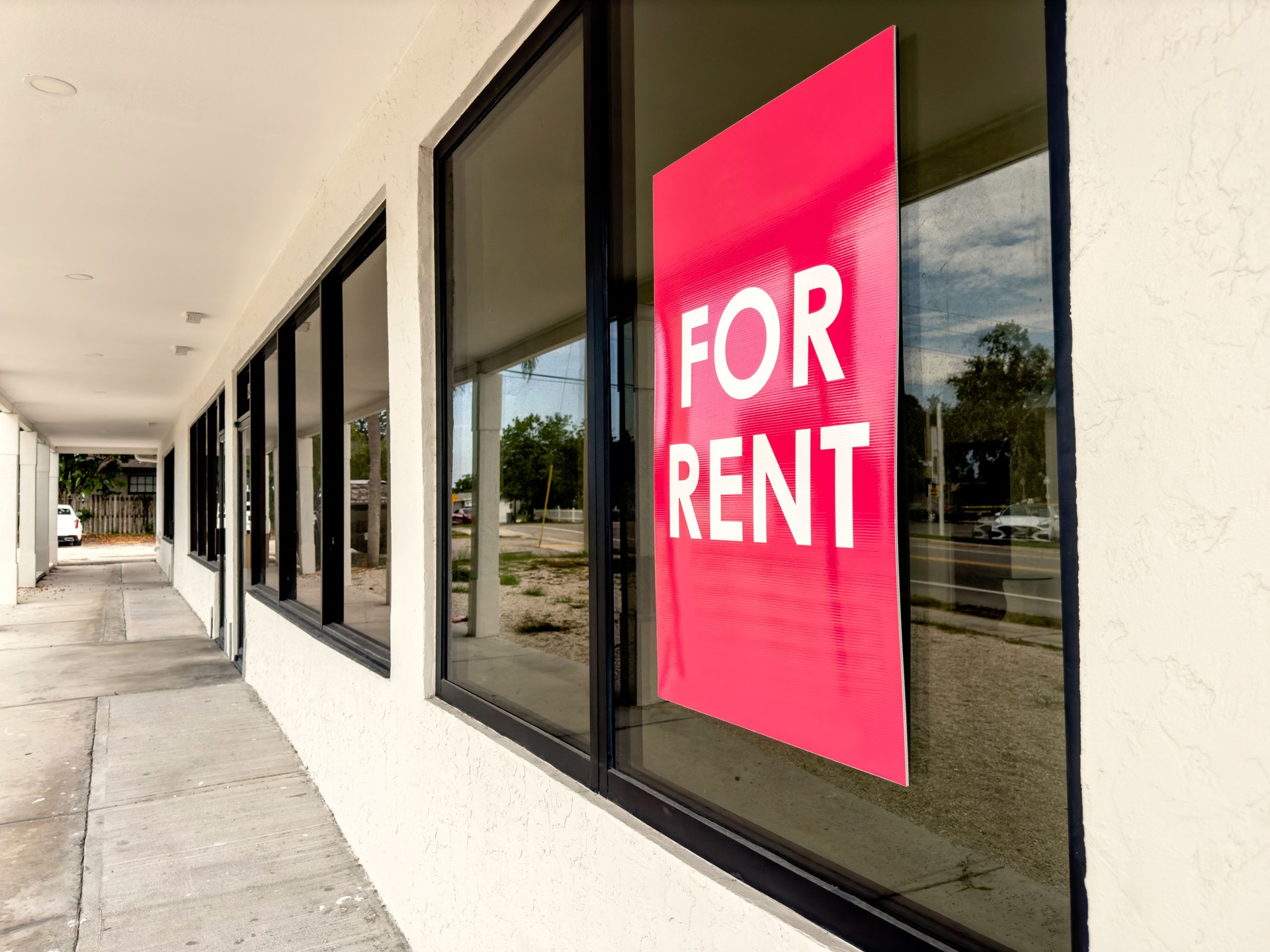 For rent sign attached on exterior glass window